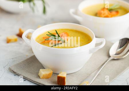 Fischsahnesuppe mit Lachs, Käse, Kartoffeln und Kräutern in weißen Suppenschalen. Stockfoto