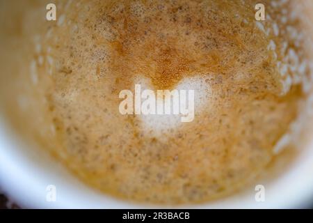 Ein Herzmuster in übrig gebliebenem Kaffeeschaum Stockfoto