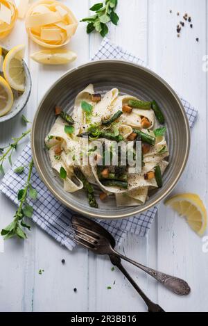 Tagliatelle in einer Cashew-Nusscreme mit gegrilltem grünen Spargel und geräuchertem Tofu Stockfoto