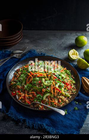 Veganer knuspriger Quinoa-Salat mit Karotten, Paprika, Koriander, Limetten, Sesamsamen, Sesamöl und Penut-Butter-Dressing Stockfoto