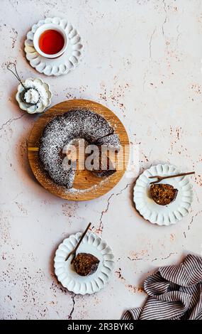 Scheiben von Chai Spiced Date Cake mit Puderzucker-Staubwischen Stockfoto