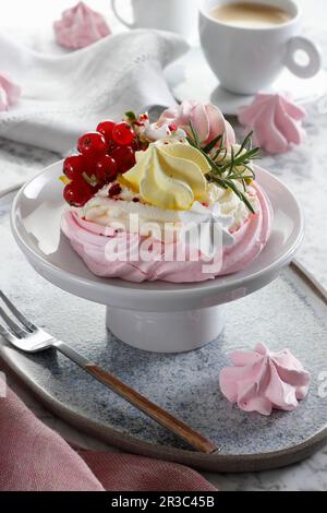 Mini-Baiser-Kuchen mit Sahne, Beeren und Pistazien Stockfoto