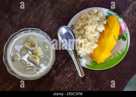 Thailändische Desserts: Banane in Kokosmilch und klebriger Reis mit Mango Stockfoto