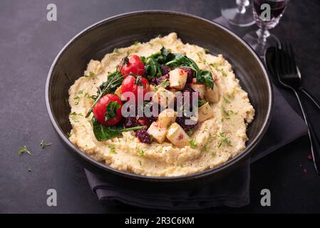 Cremige Polenta mit Rote Bete, Sellerie, Spinat und Tomaten Stockfoto