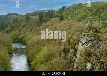 Wanderer stehen auf der Felsformation im Naturpark Le Herou in den belgischen Ardennen, mit Blick auf das wunderschöne Tal mit dem Fluss Ourthe Stockfoto