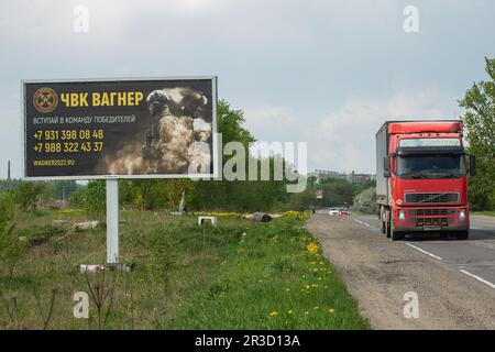 Sankt Petersburg, Russland. 22. Mai 2023. Ein Lkw fährt an einer Plakatwand vorbei, auf einer Autobahn in der Nähe von St. Petersburg in der Region Leningrad mit russischen Soldaten und einer Anzeige für eine private Militärfirma, PMC Wagner, mit der Aufschrift „Join the winning Team“. Am 20. Mai 2023 erklärte der Gründer einer privaten Militärgesellschaft, Yevgeny Prigozhin, dass die PMC Wagner Group die Stadt Bakhmut vollständig unter ihre Kontrolle genommen habe. (Credit Image: © Artem Priakhin/SOPA Images via ZUMA Press Wire) NUR REDAKTIONELLE VERWENDUNG! Nicht für den kommerziellen GEBRAUCH! Stockfoto