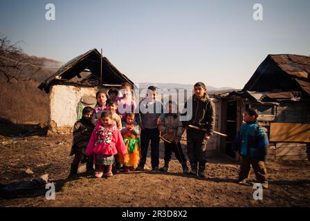 SEREDNIE, UKRAINE - 09. MÄRZ 2011: Kinder sind glücklich, nicht auf die Armut in der Umgebung zu achten Stockfoto