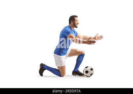 Ein Fußballspieler kniet und wartet darauf, jemanden isoliert auf weißem Hintergrund zu umarmen Stockfoto
