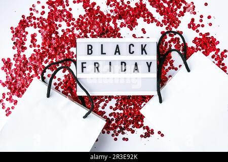 Lightbox mit SCHWARZEM Text AM FREITAG auf weißem Hintergrund mit Einkaufstaschen aus Papier, Verkaufskonzept. Template: Black friday-Angebote Stockfoto