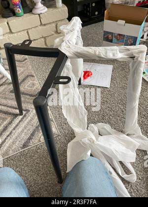 Auspacken und Zusammensetzen von Essensstühlen aus Metall Stockfoto