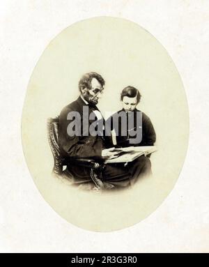 Abraham Lincoln sieht sich ein Fotoalbum mit seinem Sohn Tad Lincoln an, 1864. Stockfoto