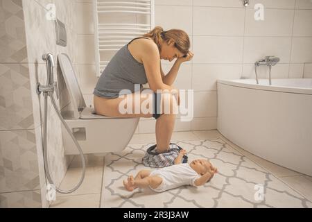 Müde depressive Mutter mit weinenden Neugeborenen Stockfoto