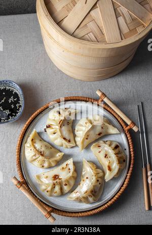 Gyoza japanische koreanische Knödel auf grauem Teller auf dem Tisch. Draufsicht Stockfoto