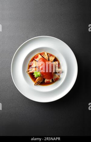 In Likör getränkte Krabben auf dem Teller，in Weinkonserven konservierte Krabben Stockfoto