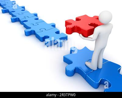 Der Mann, der das letzte Puzzleteil legt Stockfoto