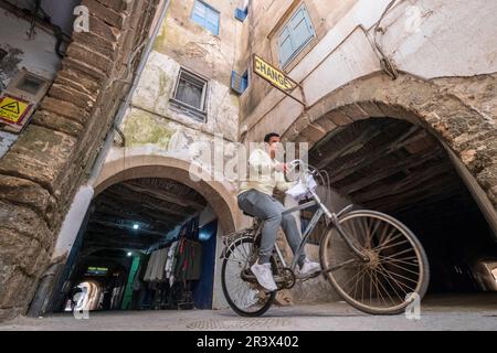 Ein Junge auf einem Fahrrad, der die Skala der Kasbah überquert Stockfoto