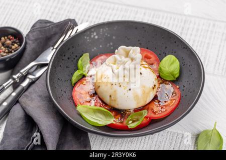 Antipasto mit Burratakäse, Tomaten und Basilikum. Italienische Küche Stockfoto