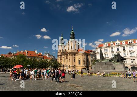 ALTSTÄDTER RING, PRAG, TSCHECHISCHE REPUBLIK - Jan-Hus-Gedächtnisstatue auf der rechten Seite und Kirche St. Nikolaus. Stockfoto