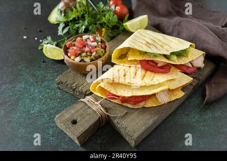 Gesundes Mittagessen. Tortilla-Sandwich, mexikanische Wraps mit gegrilltem Hähnchenfilet und Avocado, serviert mit Guacamole. Speicherplatz kopieren. Stockfoto