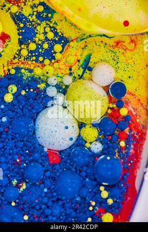 Vertical of bubbling blue white yellow and red abstract painting of background Stockfoto
