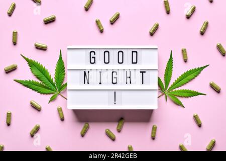 Cannabisextrakt-Kapseln, Hanfblätter und GUTE-NACHT-Briefe-Lightbox. Beruhigungs-, Anti-Stress- und Schlafkonzept Stockfoto