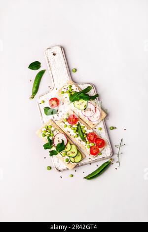 Gesunde Sandwiches mit Weichkäse und rohem Gemüse auf knusprigem Brot Stockfoto