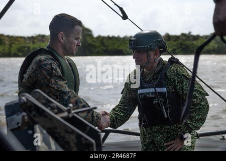 USA Oberstleutnant Timothy Riemann, Inspektor des 4. Assault Amphibian Battalion, schüttelt einem kolumbianischen Marine die Hand, während er an Bord eines kolumbianischen Marine Corps Kampfschiffes auf dem Fluss Atrato in der Nähe des kolumbianischen Marinebasis Turbo, Turbo, Kolumbien, 24. Januar 2023 ist. USA Marinekorps, Lieutenant General David Bellon, Kommandeur der USA Marine Corps Forces, Süd und USA Die Reserve der Marinekorps, seine Mitarbeiter und die Führer des 4. Assault Amphibienbataillons reisten nach Kolumbien, um sich mit der Führung des Infantería de Marina Colombiana (kolumbianisches Marinekorps) zu treffen und die Festigung von t fortzusetzen Stockfoto