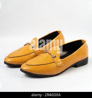 Leuchtend gelbe Slipper mit schwarzen Akzenten an den Seiten. Männerschuhe. Stockfoto