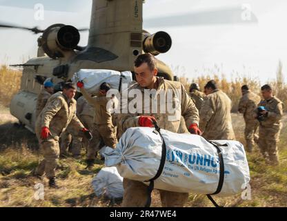 Türkisches Militärpersonal transportiert Hilfsmittel (Zelte) aus den USA Army CH-47 Chinook Helikopter in Kirikhahn, Türkiye, 18. Februar 2023. 1AD CAB bietet eine dynamische Hubkapazität zur direkten Unterstützung der Hilfsmaßnahmen der USAID und der Türkei. 1AD CAB ist eine von mehreren US-Militäreinheiten, die Task Force 61/2 (TF 61/2) unterstützen und unter US-amerikanischer Führung tätig sind Sechste Flotte, USA Marine Forces Europe (NAVEUR) und USA Europäische Befehlshaber sind Teil der internationalen türkischen Katastrophenhilfe. Stockfoto