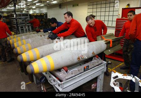 US Navy Aviation Ordnancemen sammeln Bomben an Bord der USS Theodore Roosevelt (CVN 71) Stockfoto