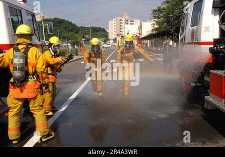 US Navy Feuerwehrleute vom Commander U.S. Marine Forces Japan Regional Fire Department reagiert auf eine Massenübung für Opfer, die in der Sullivans Grundschule von Yokosuka stattfindet Stockfoto