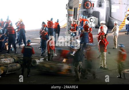 Mitglieder der US Navy Crew an Bord der USS Nimitz (CVN 68) transportieren Waffen und Vorräte vom militärischen Sealift-Kommando (MSC), dem schnellen Kampfschiff USNS Bridge (T-AOE 10) zur Hangarbucht an Bord der USS Nimitz (CVN). Stockfoto