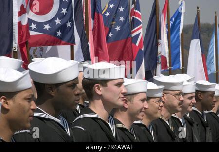 Mitglieder der US Navy Crew, die dem geführten Raketenkreuzer USS Vincennes (CG 49) der Klasse Ticonderoga zugewiesen sind, stehen vor einer Reihe von Staatsflaggen. Stockfoto