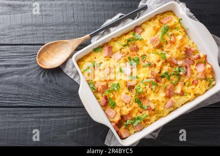 Osterreichischer gebackener Schinken, Käse und Nudelauflauf als Nahaufnahme auf dem Backblech auf dem Tisch. Horizontale Draufsicht von oben Stockfoto