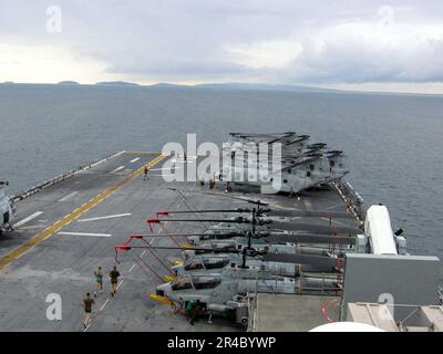 US Navy Marines von Elementen der Marine Expeditionary Brigade 3. (3D MEB) laufen auf dem Flugdeck an Bord des Amphibienschiffs USS Essex (LHD 2), während sie die Gewässer rund um Verde Island durchqueren. Stockfoto