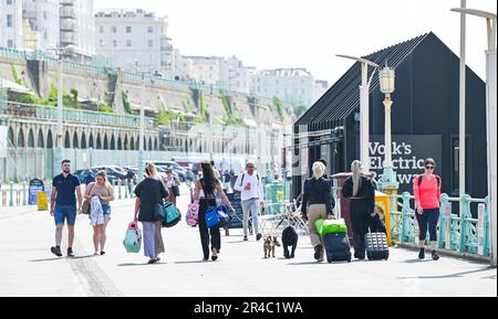 Brighton UK 27. Mai 2023 - Besucher kommen an der Küste von Brighton an, während sie die Sonne am Wochenende der Feiertage genießen, die für die meisten britischen Länder in den nächsten Tagen vorhergesagt wird : Credit Simon Dack / Alamy Live News Stockfoto