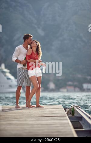 Mann und Frau flirten auf dem See Dock. Ein junges Paar, das Sommerspaß hat Stockfoto