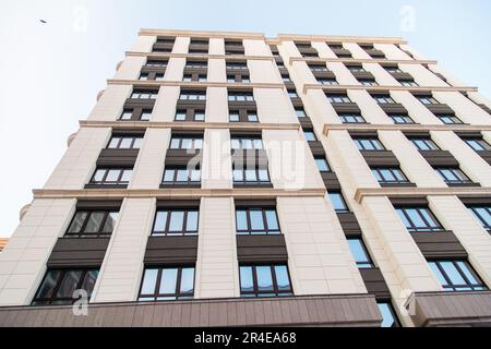 Teil eines modernen Wohnappartements mit flachem Gebäude. Detail eines neuen Luxushauses und Wohnkomplexes. Fragment von Immobilien in der Stadt Stockfoto