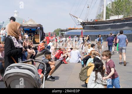 Greenwich London UK 27. Mai 2023 Wetter in Großbritannien. Große Menschenmassen in Cutty Sark London an einem sehr sonnigen und warmen Samstag und genießen eine kleine Hitzewelle im Frühsommer. Kredit: Xiu Bao/Alamy Live News Stockfoto