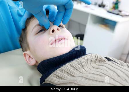 Osteopath behandelt das Atemsystem des Kindes auf der Liege in der Klinik Stockfoto