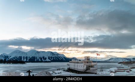 MV Tarahne in Atlin, British Columbia, Kanada während der Wintersaison bei Sonnenuntergang. Stockfoto