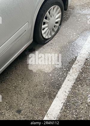 Fahrzeugreifen platzen auf nassen Parkplätzen Stockfoto