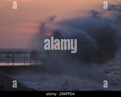 Sheerness, Kent, Großbritannien. 29. Mai 2023. Wetter im Vereinigten Königreich: Sonnenuntergang in Sheerness, Kent, während Wellen von starken nordöstlichen Winden über dem Neptune Jetty brechen. Kredit: James Bell/Alamy Live News Stockfoto