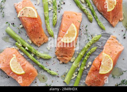 Frischer, köstlicher Lachs, grüner Spargel und Zitrone auf der Kochpfanne Stockfoto