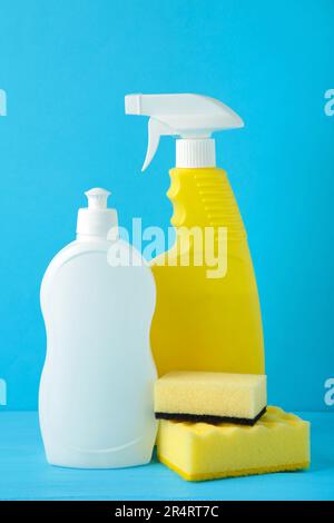 Sprühgerät mit Lappen und Schwamm zur Reinigung auf blauem Hintergrund. Draufsicht Stockfoto