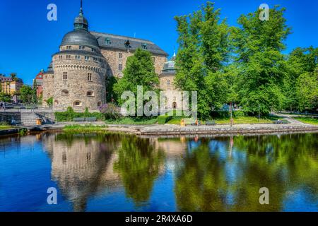 Das alte Schloss in Örebro, umgeben von Wasser und Bäumen Stockfoto