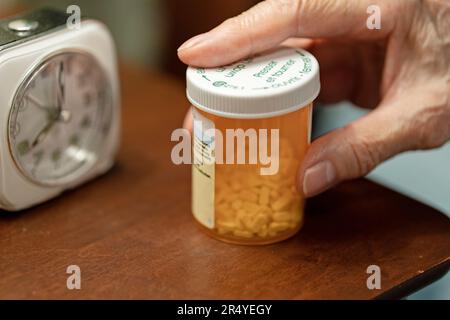 Ältere Person Hand auf verschreibungspflichtigen Pillen Flasche, Seniorenweibchen Holding Stockfoto