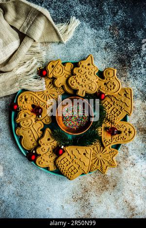 Leckere Kekse zur Weihnachtsbaumdekoration auf Betontisch Stockfoto