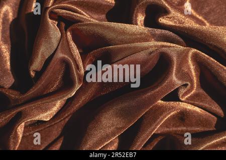Glatte, elegante Seide- oder satinierte, luxuriöse Stoffstruktur kann als abstrakter Hintergrund verwendet werden. Luxuriöses Hintergrunddesign für Weihnachten oder Neujahr Stockfoto