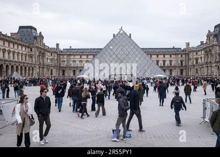 Die berühmte Louvre-Pyramide und das elegante Palais Royale stehen an einem ruhigen grauen Frühlingstag in Paris, Frankreich, Seite an Seite. Inmitten einer belebten Menschenmenge von Besuchern und Touristen verbinden diese architektonischen Meisterwerke Modernität und Geschichte und laden zu Entdeckungen und Wertschätzung ein. Erleben Sie die harmonische Mischung aus Alt und Neu, während das reiche kulturelle Erbe der Stadt inmitten der pulsierenden Energie eines beliebten Reiseziels zum Leben erwacht. Stockfoto